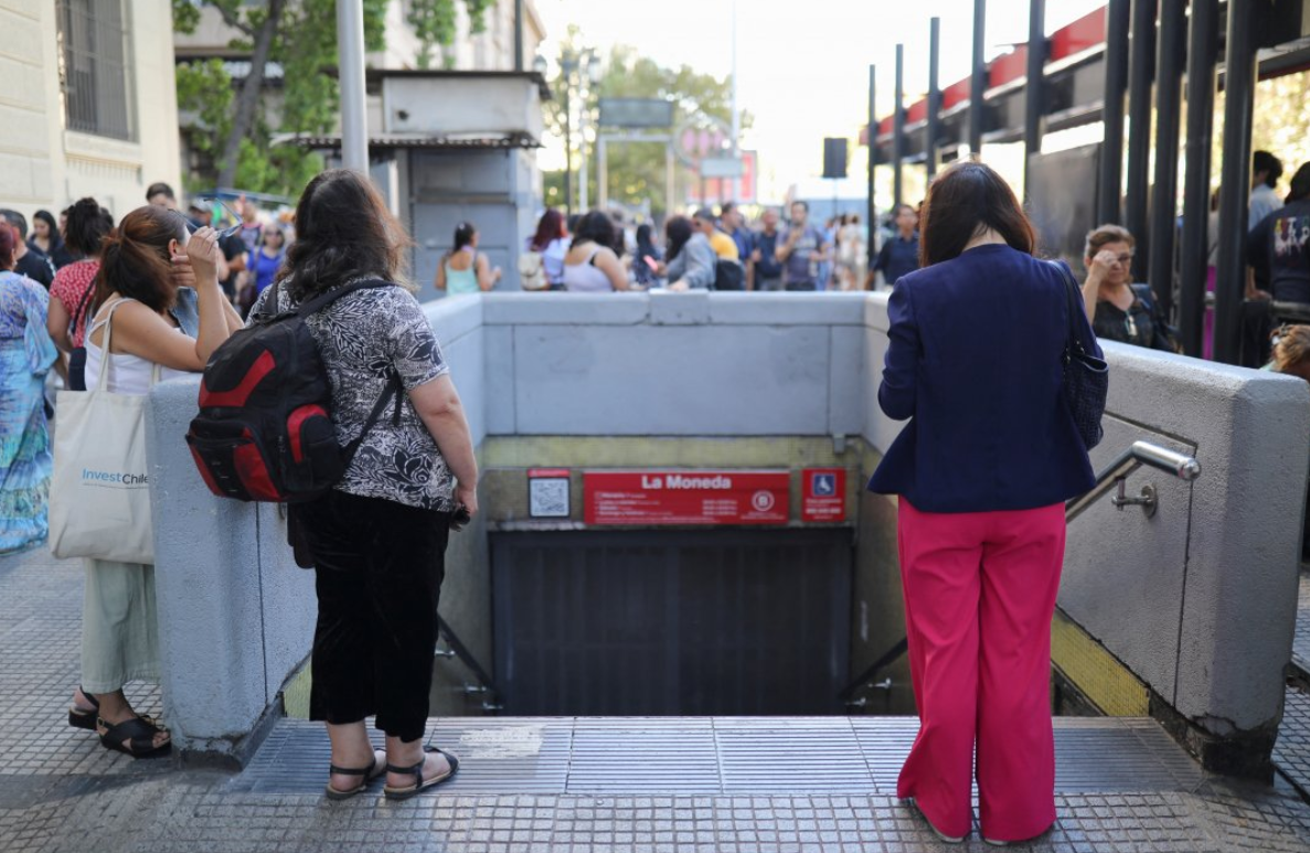 Personas esperando cerca de una boca de metro en Santiago