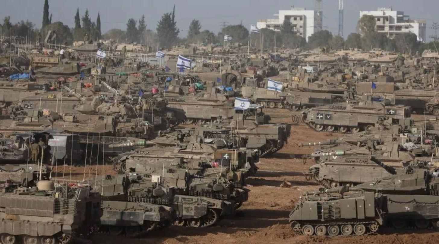 Israeli tanks and other armoured vehicles gathered near the Gaza border fence on Thursday