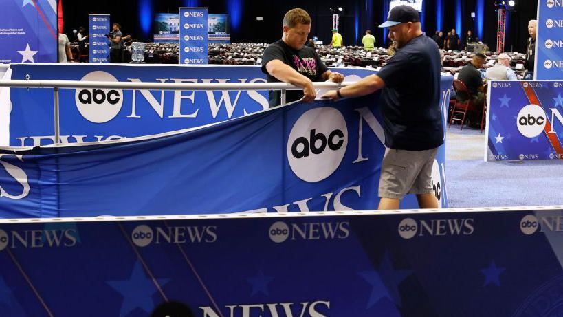 ABC News workers prepare the television set for the Harris-Trump debate