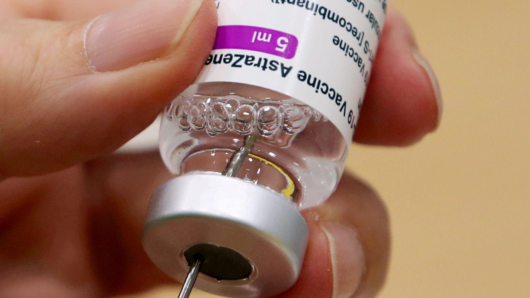 A medical worker prepares a dose of Oxford/AstraZeneca COVID-19 vaccine at a vaccination centre in Antwerp, Belgium 18 March 2021.