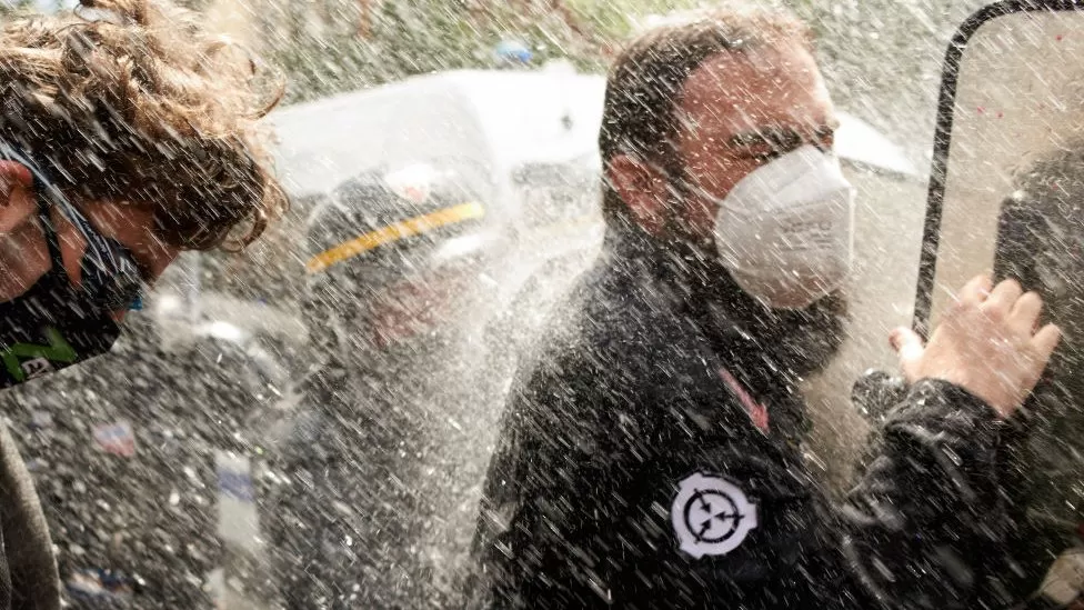 Manifestantes atingidos por canhão de água na França