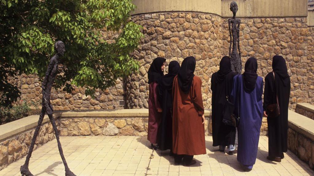 A group of veiled women viewing sculptures by Alberto Giacometti in the grounds of Tehran Museum of Contemporary Art, September 1993.