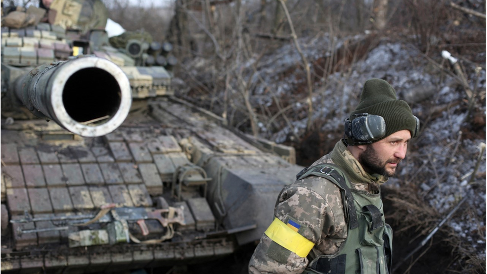 Ukrainian soldier and Soviet era tank