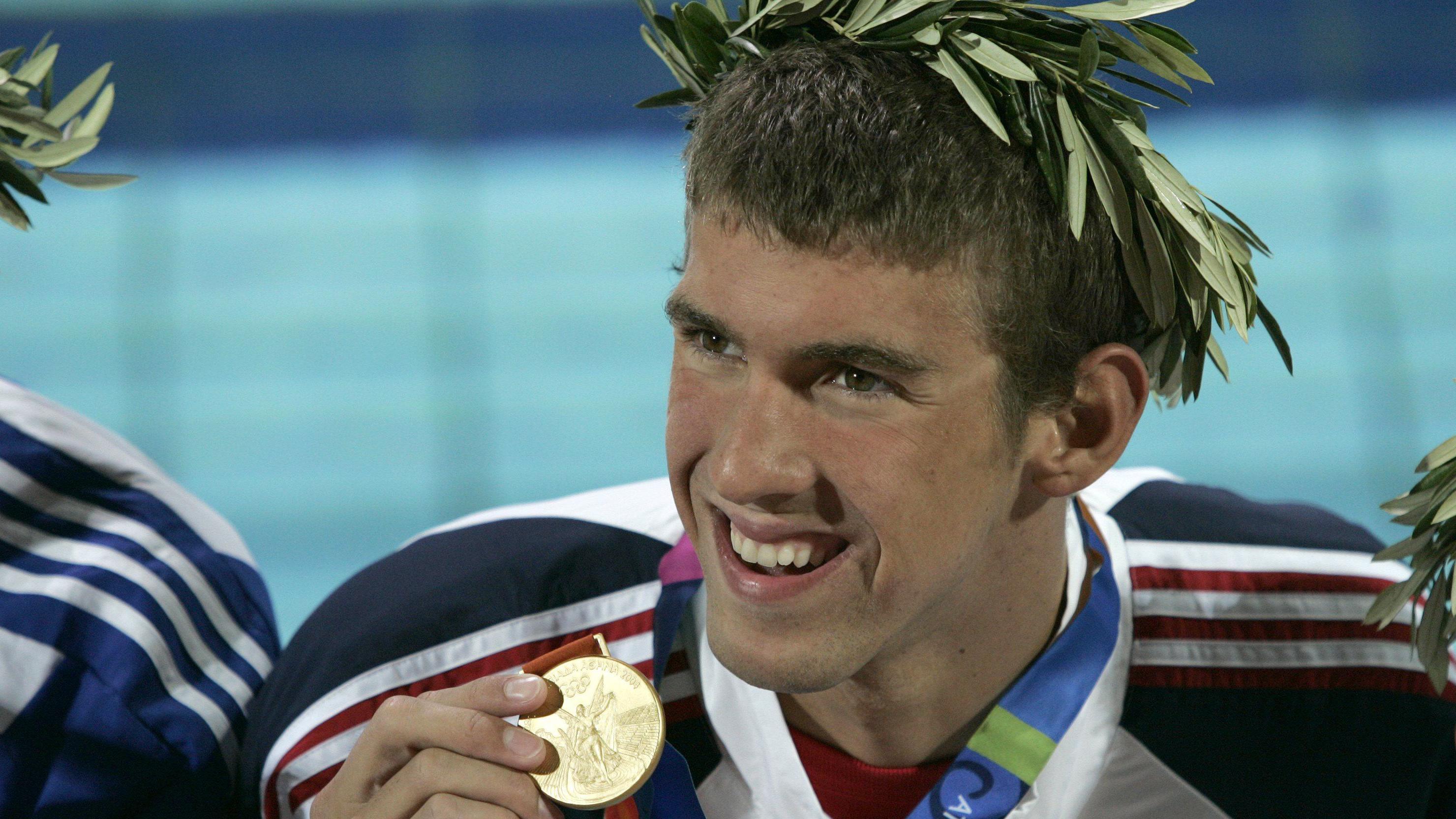 Michael Phelps mostrando su medalla de oro