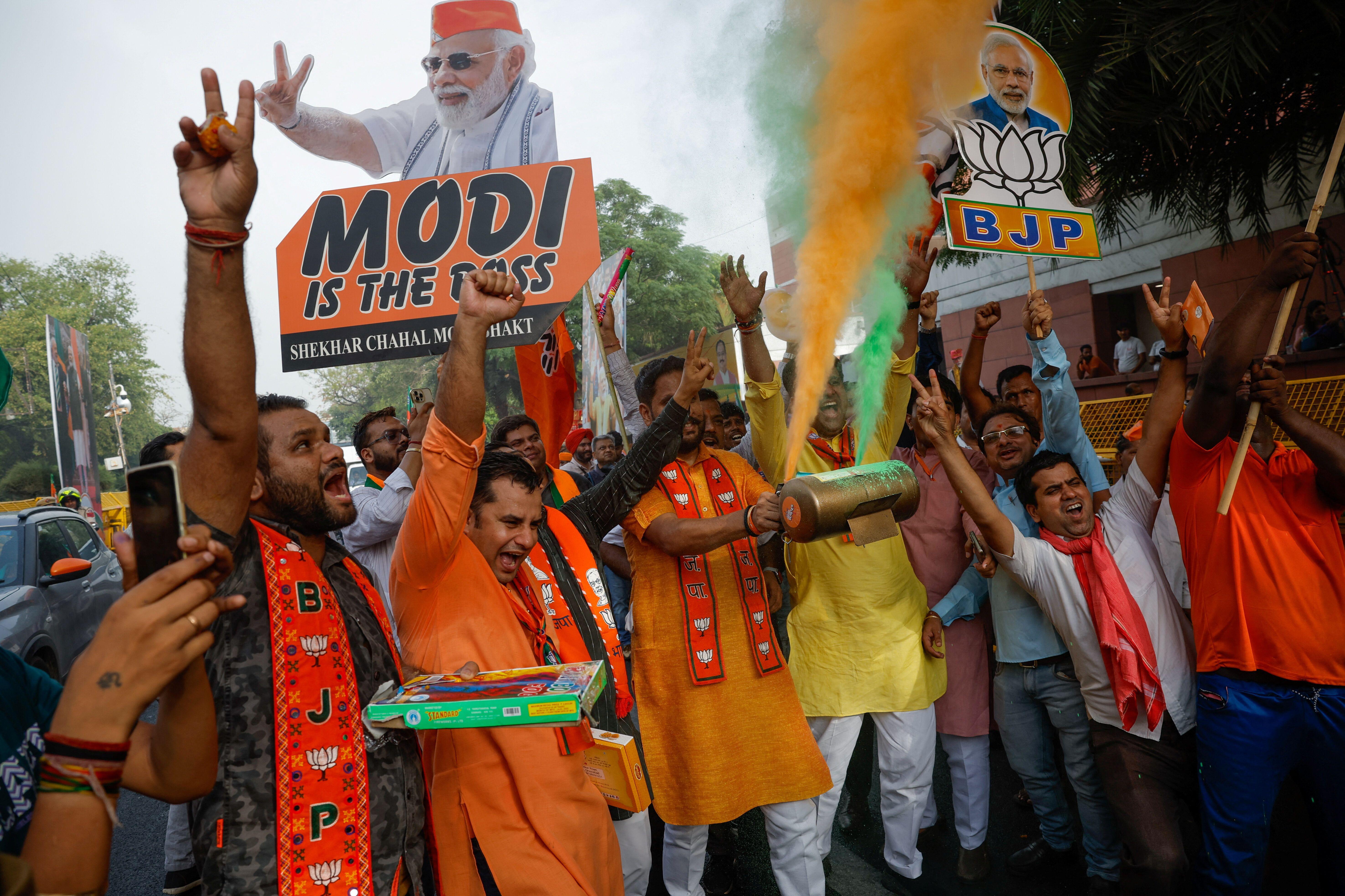 Apoiadores do Partido Bharatiya Janata (BJP) comemoram fora da sede do BJP, no dia dos resultados das eleições gerais, em Nova Delhi