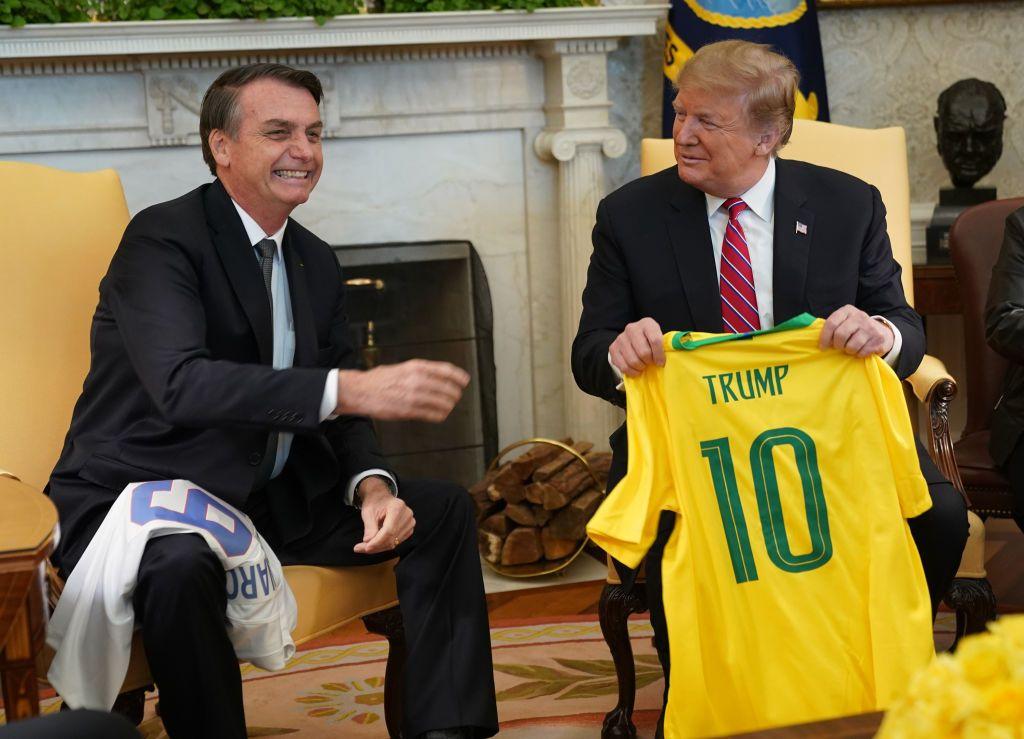 Bolsonaro e Trump trocando camisas de futebol em encontro na Casa Branca em 2019