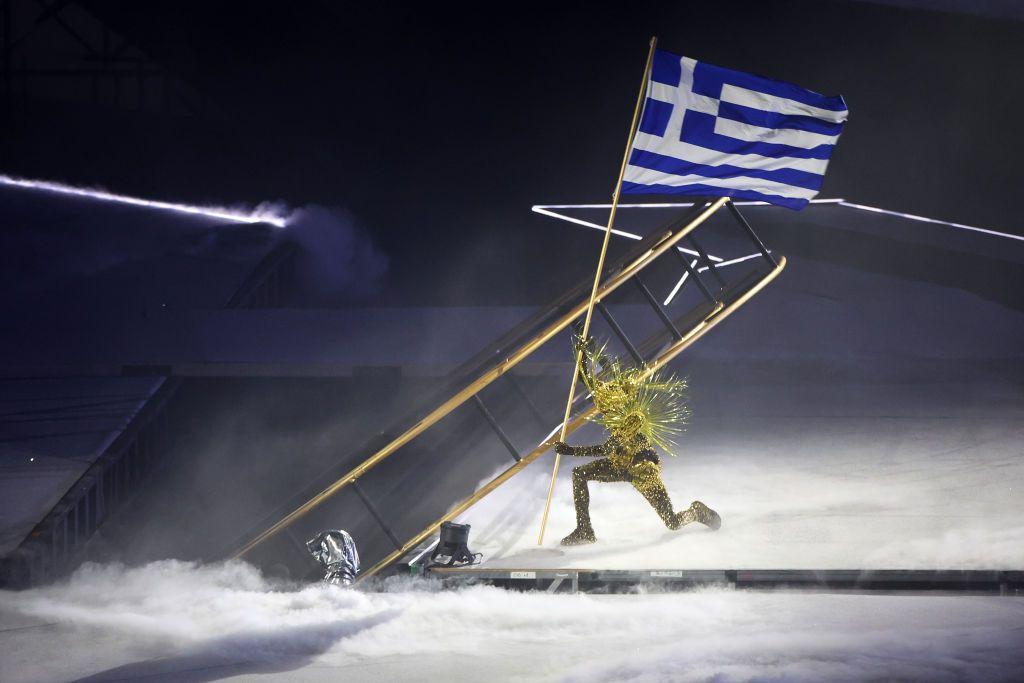 The golden traveler with the Greek flag