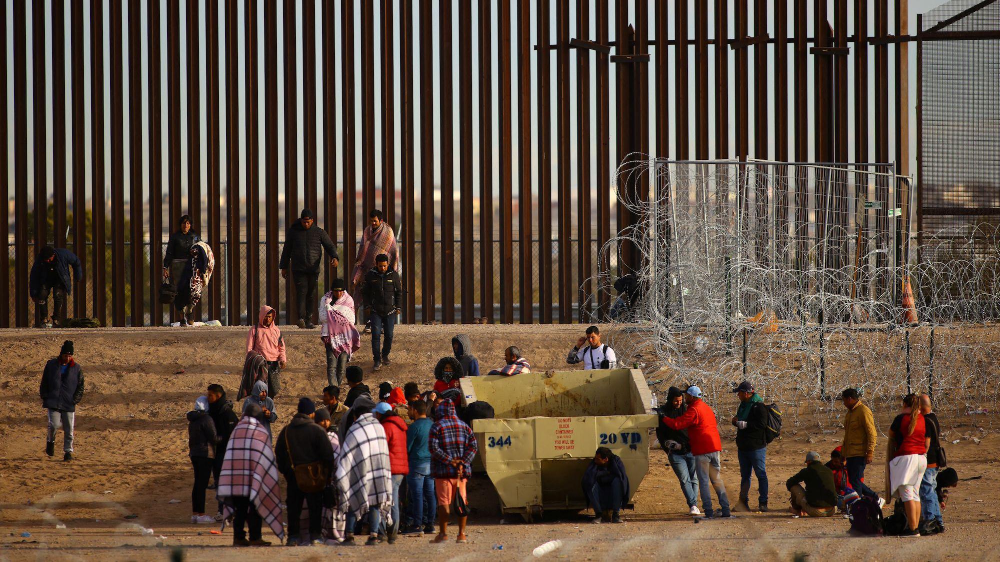 Imigrantes em muro nos EUA