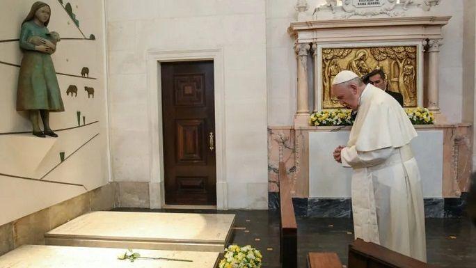 The Pope prays at the grave of Jacinta and Francisco Marto, two of the three shepherd children