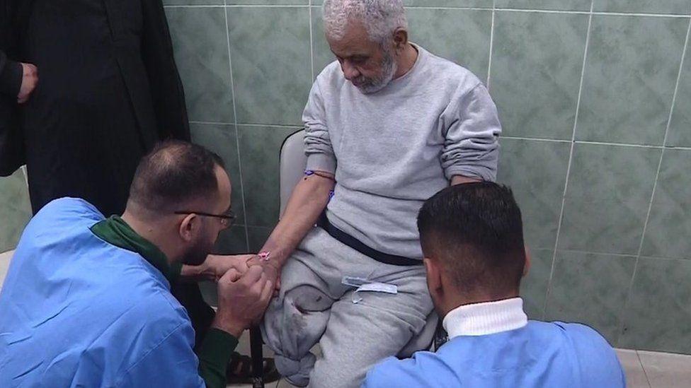 Mahmoud Abu Husein, who is missing his right leg, was attended to by medics in the hospital corridor