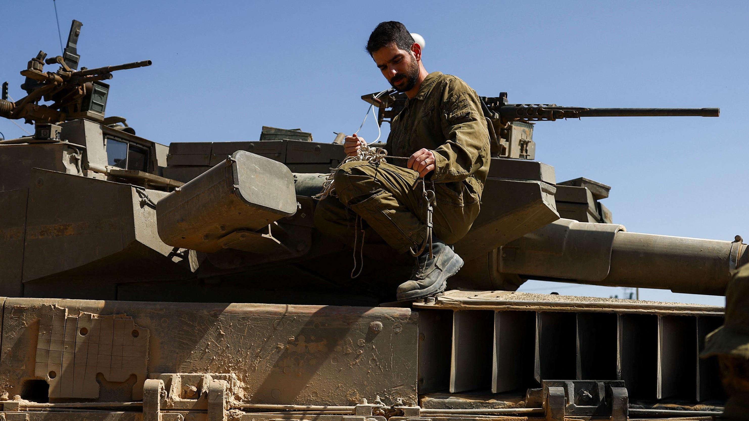 Soldados israelíes realizan labores de mantenimiento en un tanque Merkava cerca de la frontera entre Israel y Gaza.