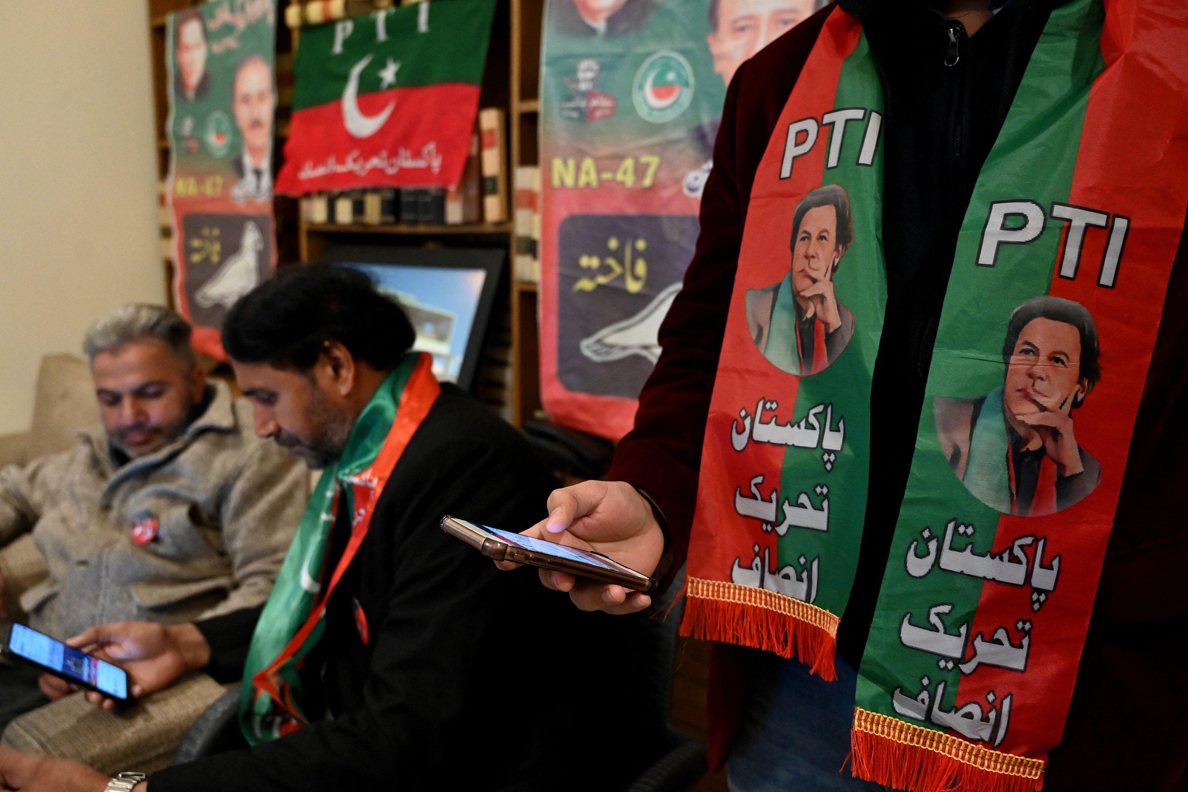 PTI supporters watching the fundraising rally online.