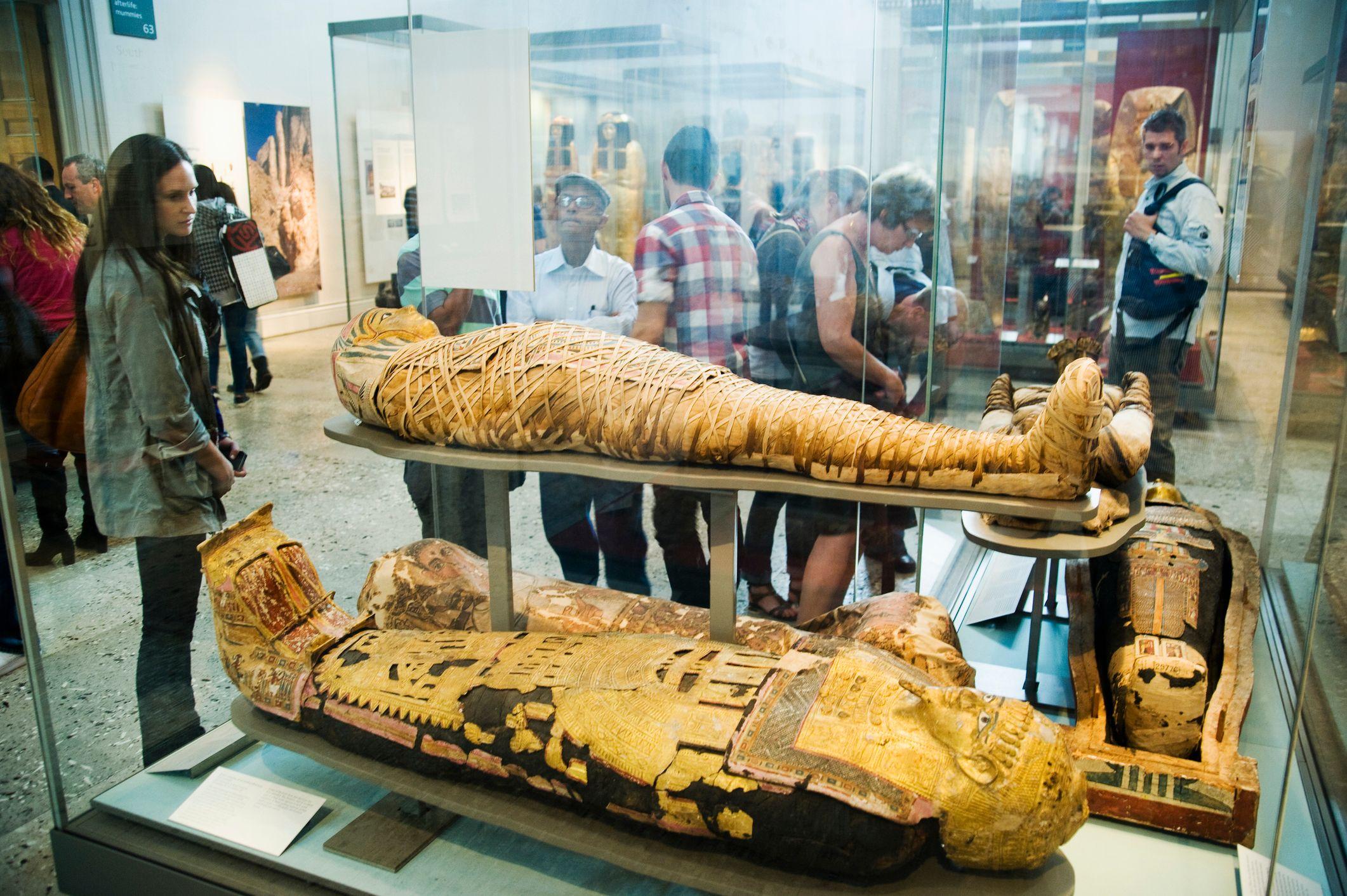 Pessoas observam múmias no museu