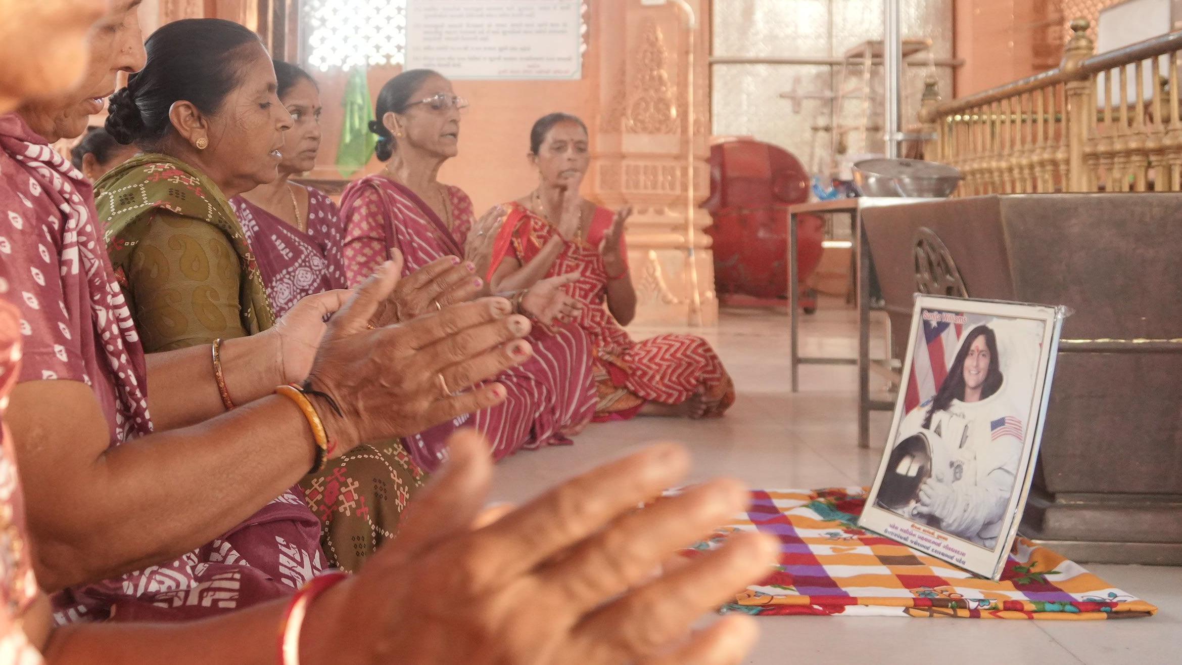 Women praying for the safe return of Sunita Williams