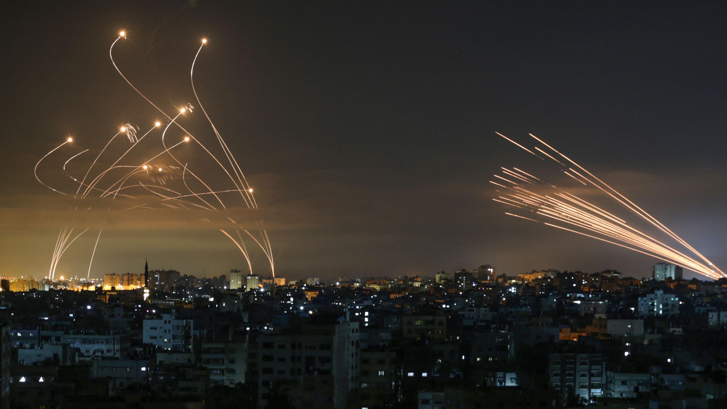 Iron Dome missiles (L) launched to shoot down rockets (R) fired from Gaza into southern Israel, May 2024