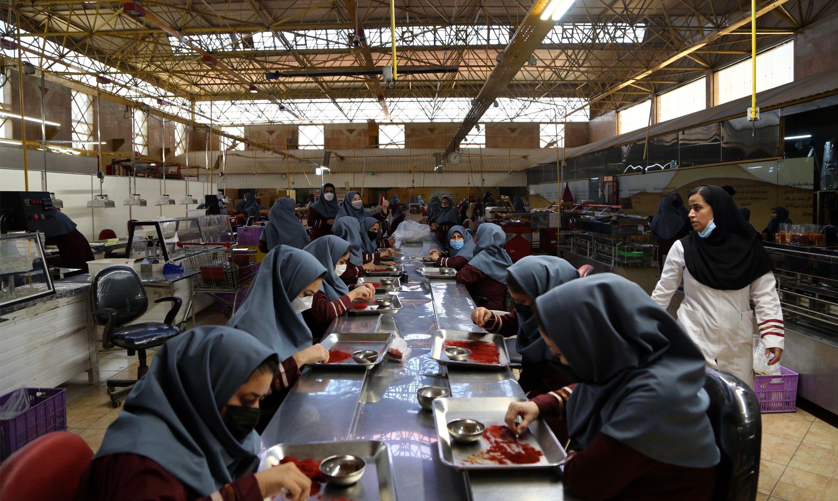 Women produce saffron at Novin Saffron company in Mashhad, Iran, in 2021