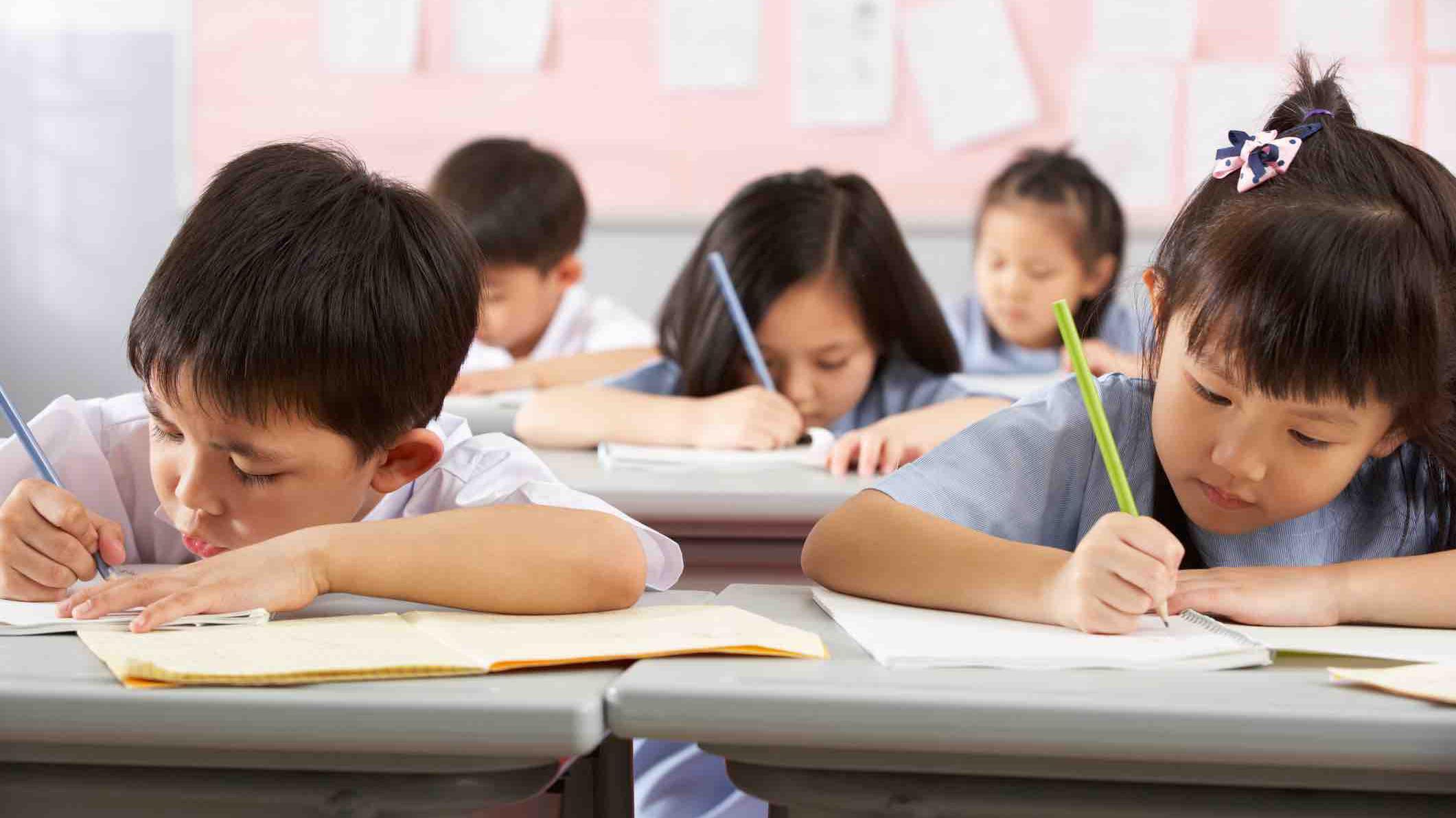 Children writing in school in China