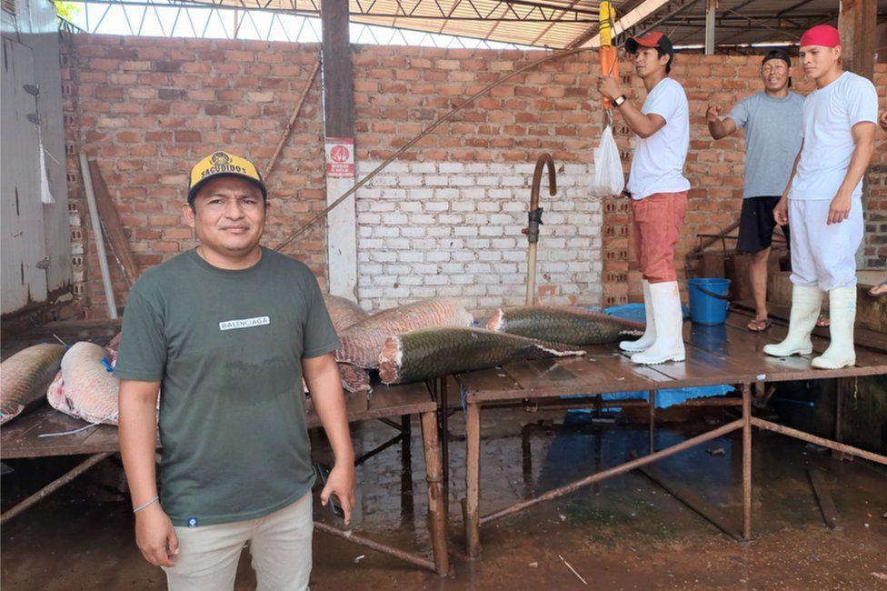 Edson Suzano junto a trabajadores en su planta procesadora de paiche