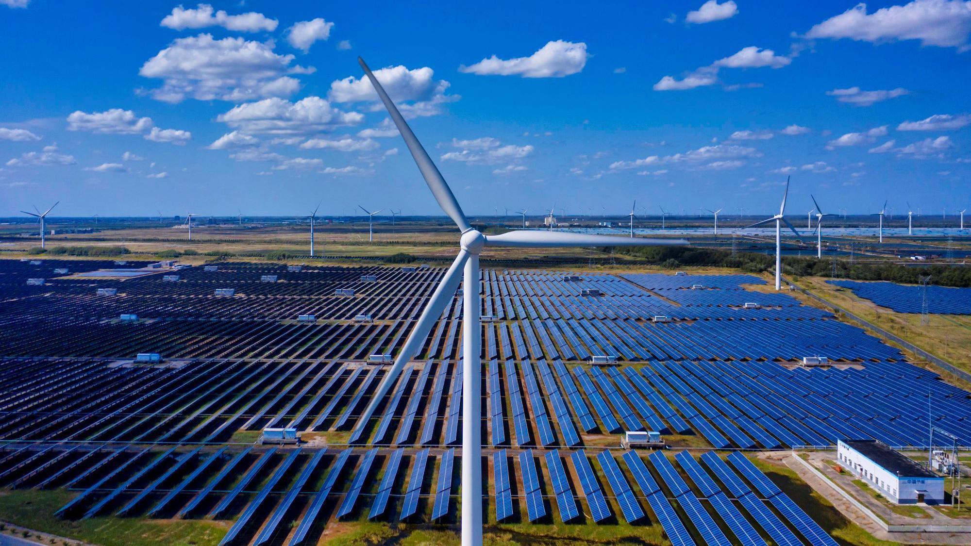 A photo made with a drone shows general view of the solar panels and wind turbines of Wind, Solar and Fishing Base in Dongtai near Yancheng, Jiangsu province, China, 14 October 2020.