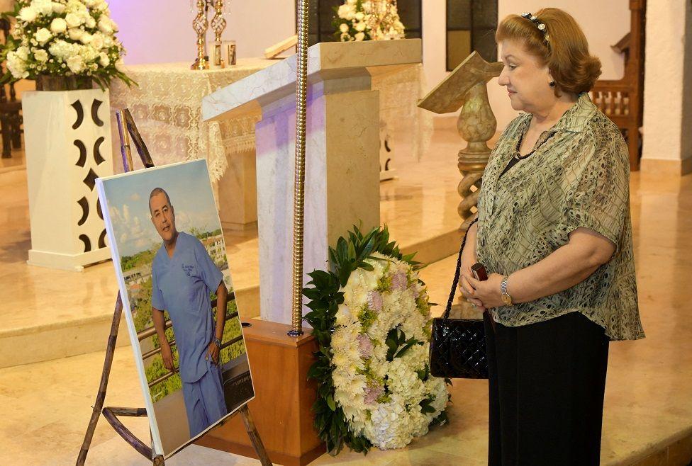 Una mujer parada al frente de una foto de Edwin Arrieta