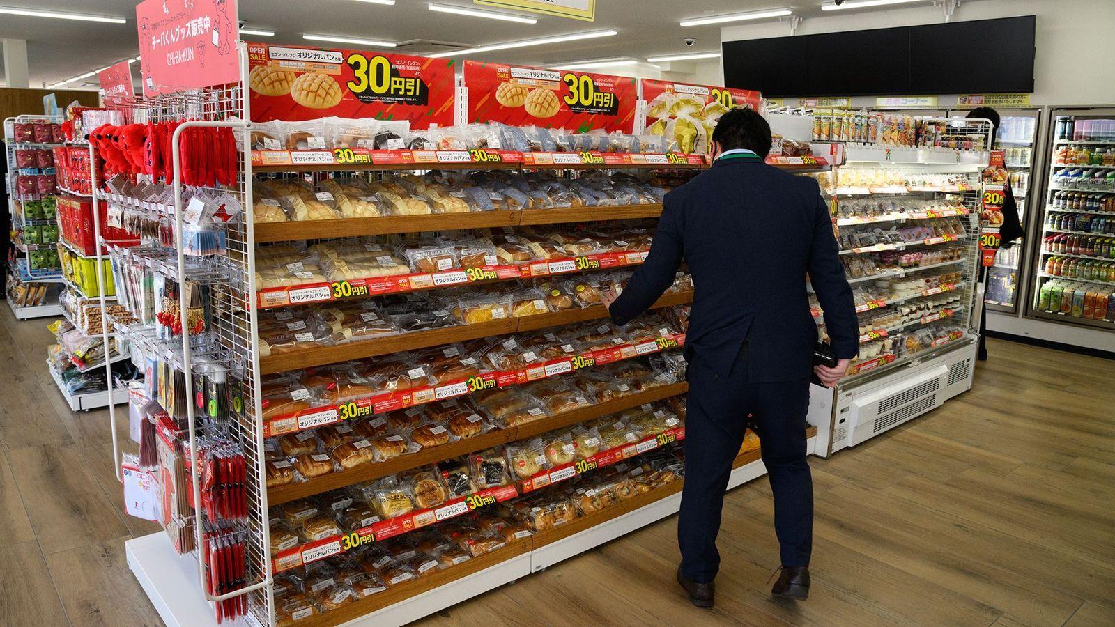 Un hombre frente a un estante de productos en un supermercado