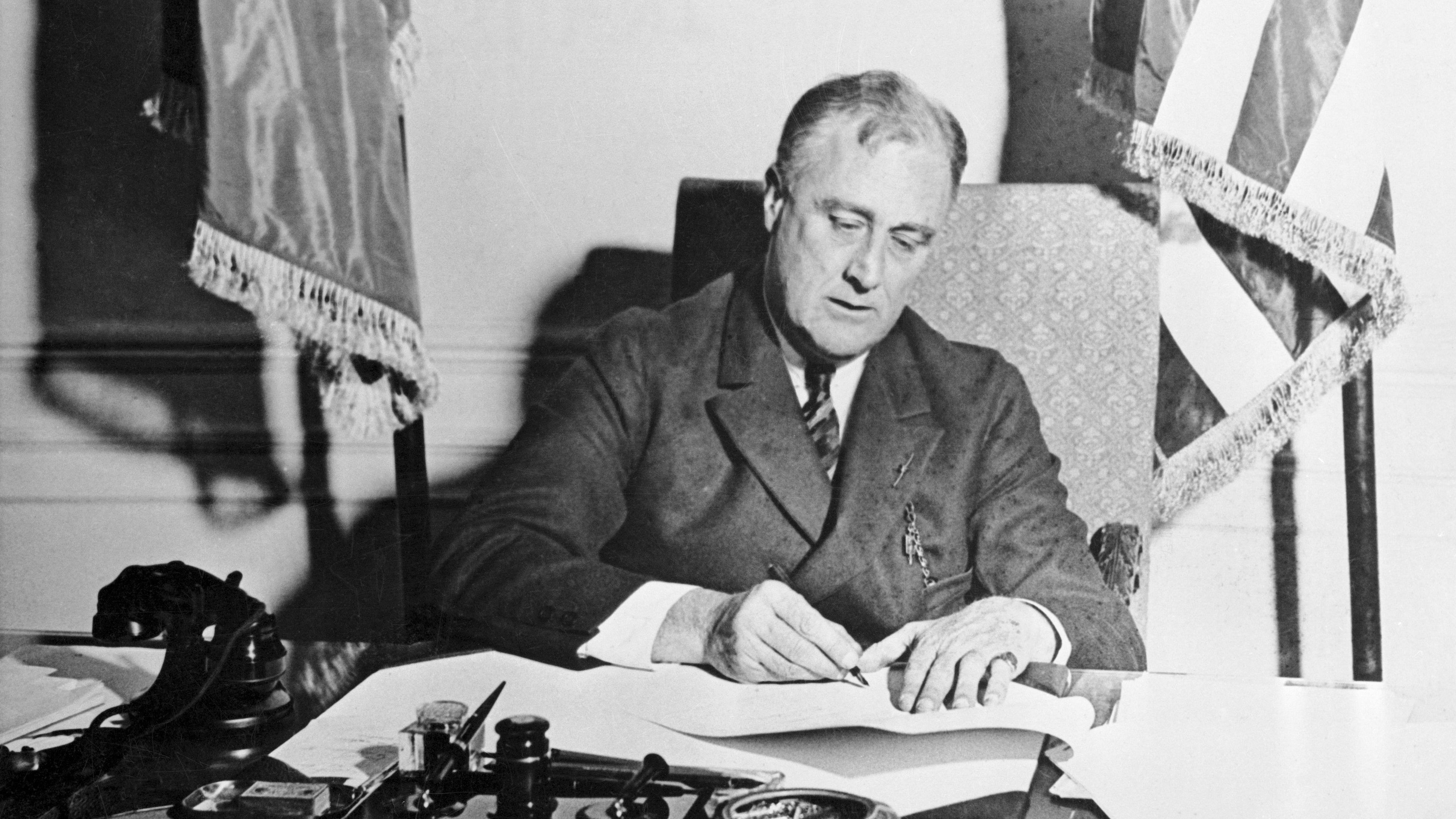 President Franklin D Roosevelt signing a pardon document at his desk