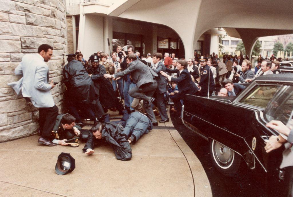 Miembros del Servicio Secreto y la policía se abalanzan para proteger al presidente Ronald Reagan durante un tiroteo en 1981.