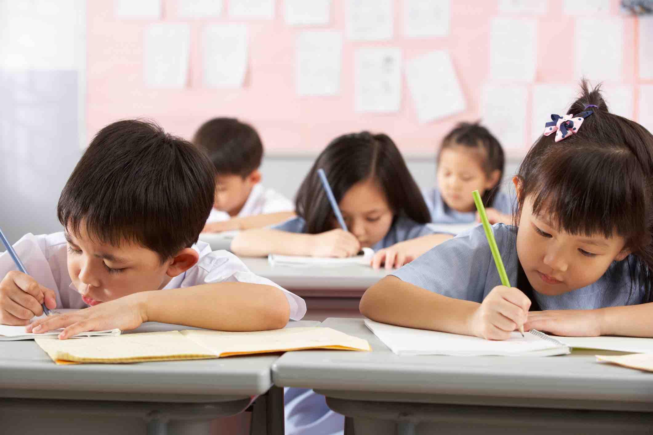 Children writing in school in China