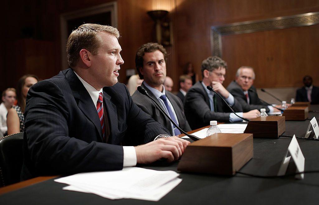 Chris Nowinski, vestido de corbata, se dirige a un comité del Congreso de EEUU.