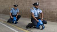 two men sitting on toy cars