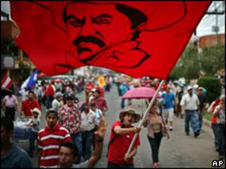 Manifestante com bandeira com imagem do presidente deposto de Honduras, Manuel Zelaya
