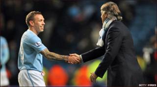 Mancini shakes hand with Bellamy after the win 2-0 over Stoke