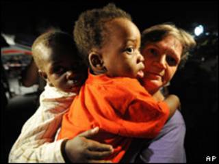 Voluntaria francesa con dos huérfanos haitianos rumbo a Francia para ser adoptados