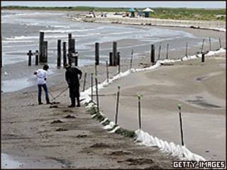 Trabalho de limpeza em praia da Louisiana (foto: Getty)