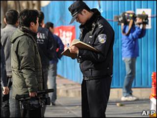 北京警察在被囚諾貝爾和平獎得主劉曉波的寓所外查核記者證件(10/12/2010)