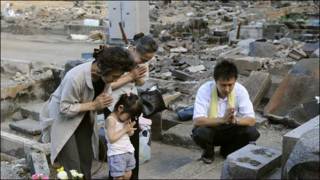 Japanese family praying after March tsunami