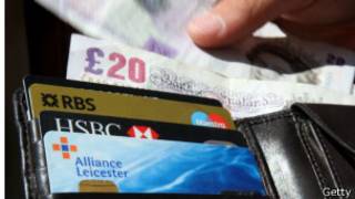 In this photo illustration a man takes a twenty pound (GPB) note from his wallet on June 17, 2008 in London, England. The governor of the Bank of England has stated that inflation could rise above 4% this year as a result of increasing prices of energy and food.