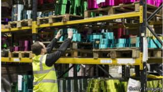 Festive employee Ryan Malson gathers stock of tinsel raw material stored in the factory part of the Festive Productions Ltd premises on December 10, 2013 in Cwmbran, Wales. Although Christmas Day 2013 is only two weeks away, the staff at Festive are already planning and gearing up for Christmas 2014. The 14 acre fully integrated showroom, factory and warehouse measuring 250000 sq ft in size holds Festive Productions, who are now the last manufacturer of tinsel in UK - with the majority of tinsel sold in the UK made at the factory in Wales. As well as tinsel, Festive, which is one of Europe's largest suppliers and manufacturer of Christmas and seasonal decorations, has increased its product portfolio, to include nearly every conceivable Christmas decoration category including baubles, tinsel garlands, wreaths, lights, fibre optic trees and artificial trees.