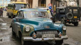 A vintage American car drives along a street in Havana on December 31, 2013. A new regulation released by Cuban President Raul Castro will allow Cubans or foreign residents to freely buy new or used cars in government-run stores as of January 3, 2014; after 50 years of automobile sales regulations. AFP PHOTO/ADALBERTO ROQUE (Photo credit should read ADALBERTO ROQUE/AFP/Getty Images)