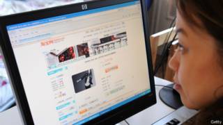 فتاة صينية تتصفح موقع تاوباو للتسوق في العاصمى بكين