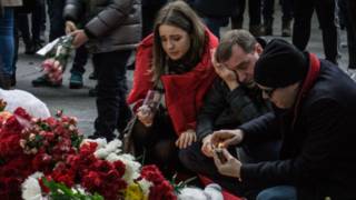 Люди у мемориала из цветов в Пулково