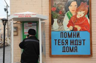 Заключенный беседует по телефону
