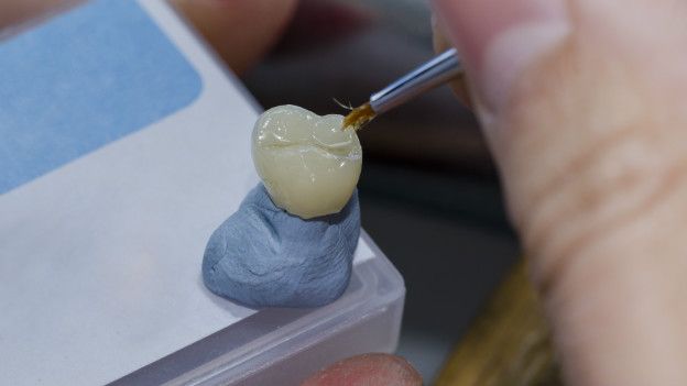 Un técnico dental haciendo un diente