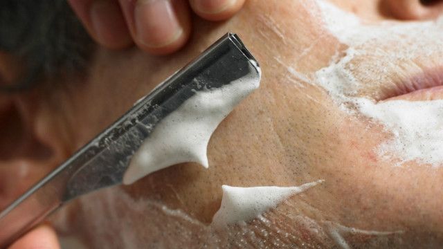 A man shaving with a razor blade