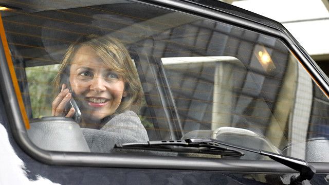 a woman sitting in the back seat of a car