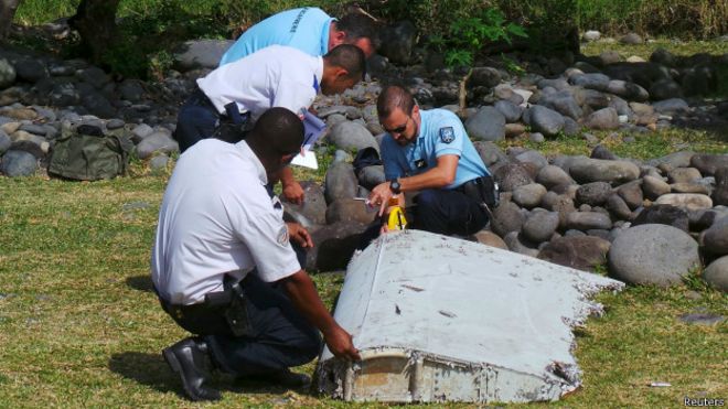 equipo de policías recoge alerón en playa de isla la Reunión