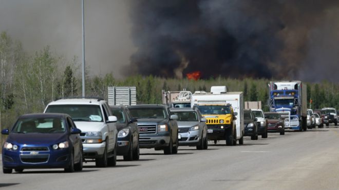 Habitantes huyendo del incendio en Fort McMurray, Canadá