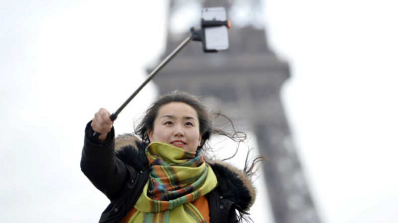 Una persona tomándose un selfie con un selfie stick