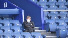 Liverpool legend Kenny Dalglish, who tested positive for coronavirus in April, wore a face mask as he watched the derby