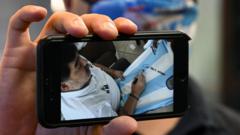 Maradona appears on a person's phone screen